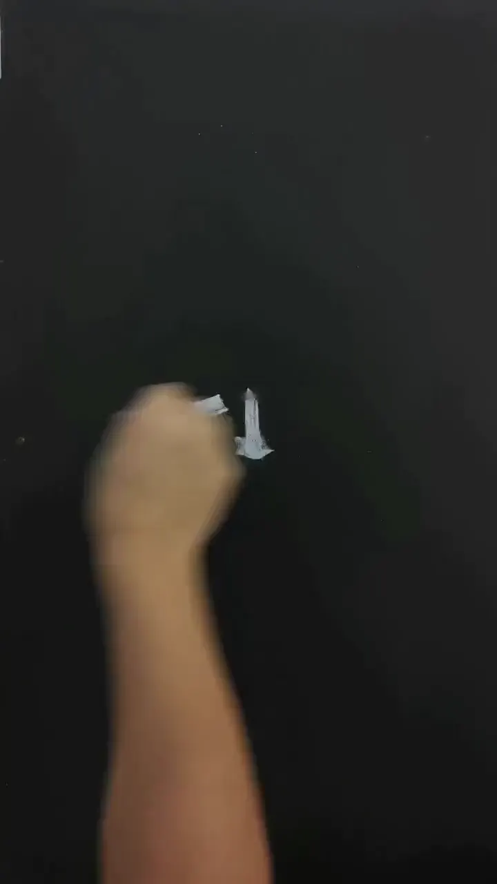 Precise brushwork creating delicate details on a tiny surface